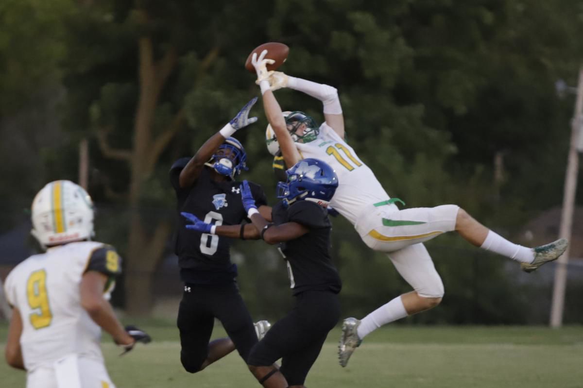 MacArthur's Jeffery Wells and Malachi Thomas push the Generals' defense